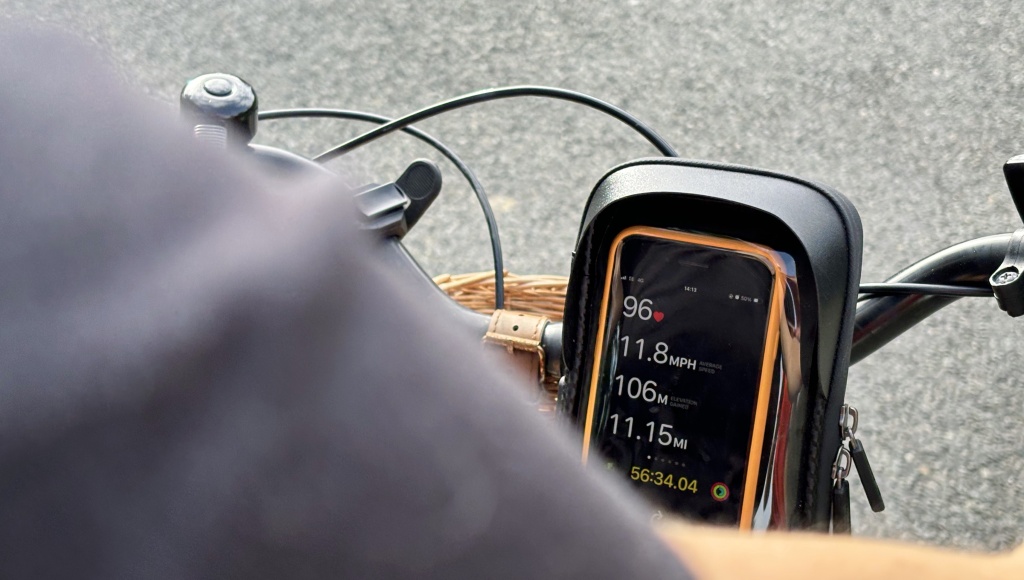 an iPhone showing running metrics during a cycle workout.